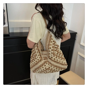 Detail of handwoven crochet tote bag showing diamond patterns and leather shoulder strap