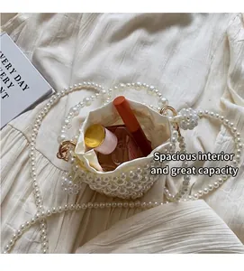 Top view showing the spacious interior of the pearl bucket bag with silk lining and strap