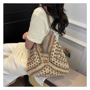Detail of hand-woven hobo bag with geometric crochet patterns and brown leather strap