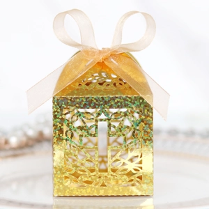 Sparkling gold glitter favor box with hollow cross design and champagne ribbon for weddings