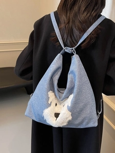 Blue denim style tote bag featuring a 3D plush dog patch and versatile shoulder straps