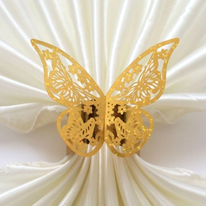 Détail macro du rond de serviette papillon doré découpé au laser avec texture pailletée