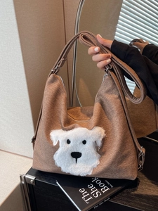 Brown canvas crossbody tote bag with cute plush dog patch and adjustable shoulder strap