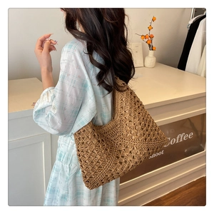 Close-up of the intricate brown hollow crochet knit pattern and texture on this summer tote