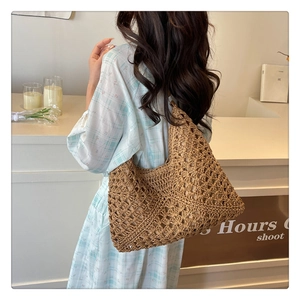 Close-up of brown hollow woven tote bag showing detailed crochet texture and integrated strap