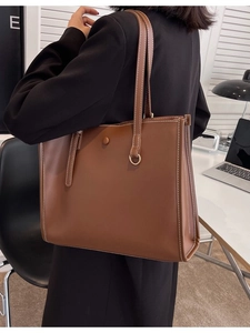 Brown large capacity leather tote bag with decorative white stitching for work