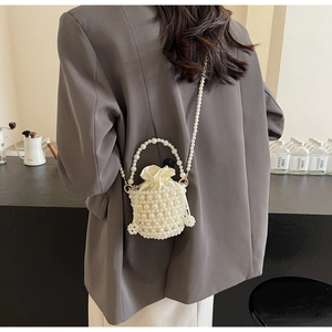 Detailed shot of handmade woven pearl bucket bag with luxury satin drawstring lining