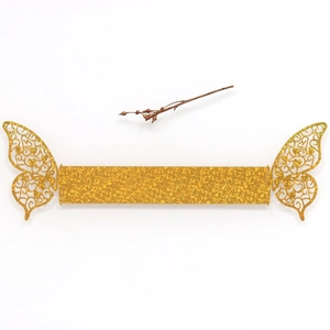 Close-up of glittery golden butterfly napkin ring with intricate hollow heart cutouts