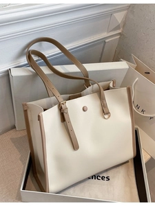 Minimalist beige faux leather tote bag with brown adjustable straps for office commuting