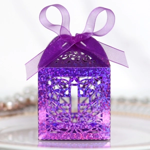Close-up of purple glitter candy box with hollow cross design and satin ribbon bow