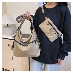 Macro detail of khaki nylon tote bag and crossbody pouch set with black zippers