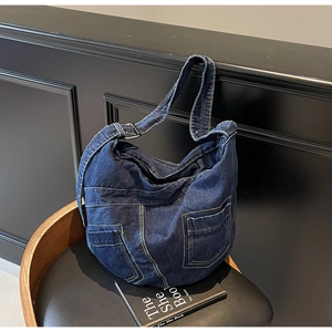 Close-up of retro large capacity denim hobo bag with contrast stitching and utility pockets
