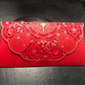 Exquisite laser-cut red envelopes with gold foil floral patterns for Chinese New Year