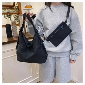 Detail of black nylon two-piece bag set showing water-resistant fabric and hardware