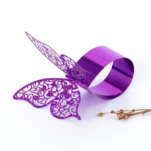 Detailed view of purple glitter hollow butterfly napkin ring with laser-cut floral patterns