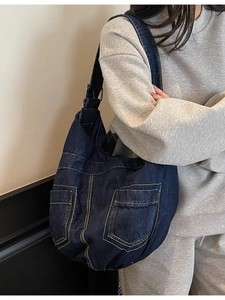 Large dark blue denim hobo bag with contrast stitching and decorative pockets