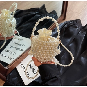 Detailed shot of handmade pearl woven bucket bag with drawstring satin lining
