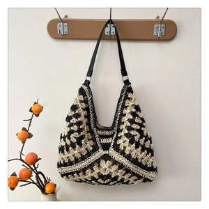 Detailed macro of the black and beige geometric woven pattern on the tote bag