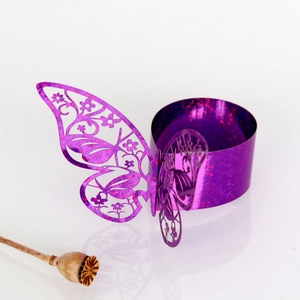 Close-up of laser-cut purple butterfly napkin ring with glitter hollowed wings