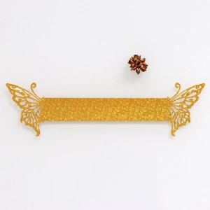 Detail of glitter gold butterfly napkin rings for wedding parties and festive events