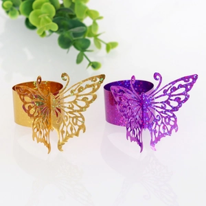 Detail of glitter butterfly napkin rings with laser-cut wings for wedding and party decor