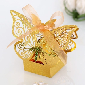 Detailed laser-cut gold butterfly candy box with shimmering texture and ribbon accent