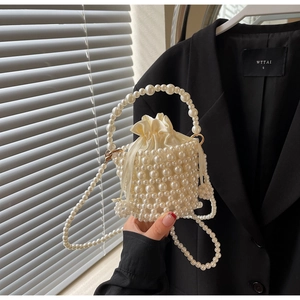 Detailed view of handmade pearl woven bucket bag with elegant silk drawstring inner pouch