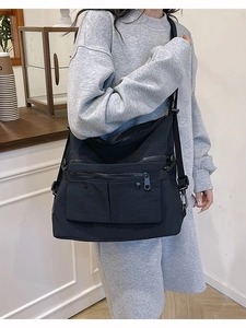 Black large capacity nylon tote bag with multiple pockets and adjustable shoulder strap