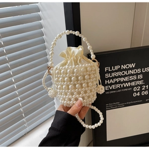 Detailed view of woven pearl bucket bag with luxury satin drawstring inner pouch