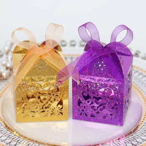 Detail of laser-cut heart pattern gift boxes with glitter finish and organza bow