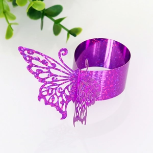 Detail of purple glitter butterfly napkin ring with laser-cut design for wedding decor