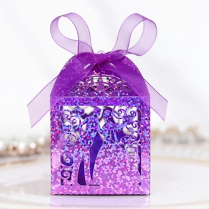 Sparkling purple laser-cut wedding favor box with glitter finish and silk ribbon bow