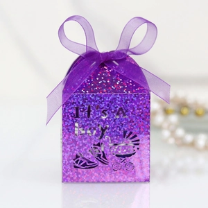 Detail of purple glitter baby shower gift box with ribbon and It's A Boy hollow design