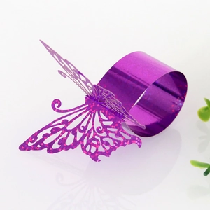 Close-up of laser-cut purple glitter butterfly napkin ring for wedding table decor