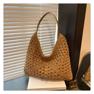 Detail of bohemian woven tote bag showing geometric hollow texture and leather strap