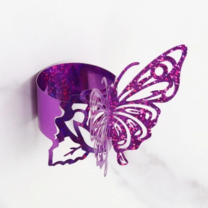 Detail of laser-cut purple glitter butterfly napkin ring with hollow wing patterns