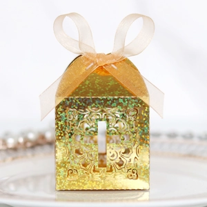 Detail of glitter golden cross cutout gift box with sheer gold organza ribbon bow