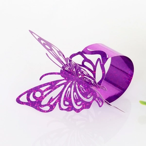 Detailed view of laser-cut butterfly napkin ring with purple glitter coating and hollow design