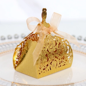 Elegant gold laser-cut candy box with rose pattern and princess dress silhouette ribbon