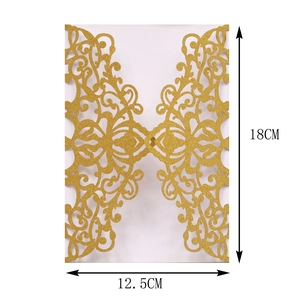 Detail of laser-cut floral scroll patterns on gold glitter wedding invitation cover