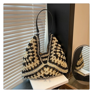 Detail showing hand-crocheted geometric pattern on a black and white woven tote bag