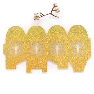 Macro detail of laser-cut cross pattern on glittering gold wedding candy favor box