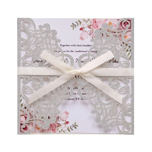 Laser cut glitter silver wedding invitation with floral inner card and white silk ribbon
