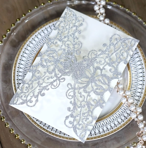 Detail of laser-cut butterfly invitation with silver glitter and white cardstock layer