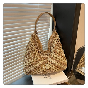 Detailed macro view of beige and brown woven geometric texture on a hobo shoulder bag