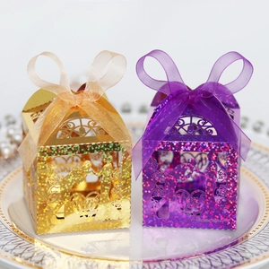 Laser cut favor boxes in gold and purple with Thank You text and organza ribbon bow