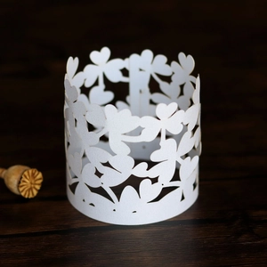 Detailed laser-cut hollow floral pattern on white pearlescent paper napkin ring decoration