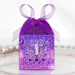 Close-up of violet glitter gift box featuring laser-cut cross and purple ribbon bow