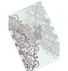 Detailed laser-cut silver glitter butterfly invitation card with intricate vine patterns