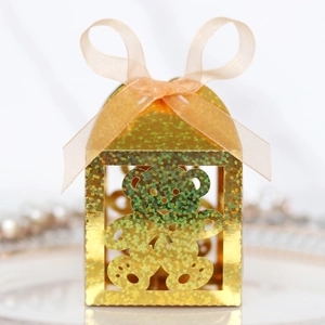 Detail of golden hollow bear gift box with glitter finish and champagne ribbon bow